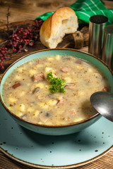 Traditional polish soup Zurek in ceramic bowl.