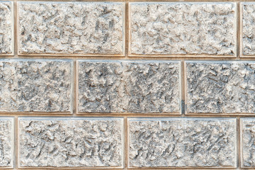 The texture of the massive wall of large gray stone. The basement of a large building.