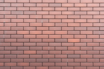 Wall texture of new modern brown brick. Building surface background. Classic brickwall.