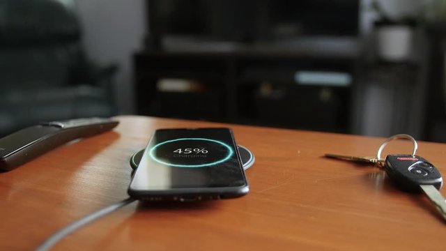 Putting Smart Phone on Wireless Charger in Living Room