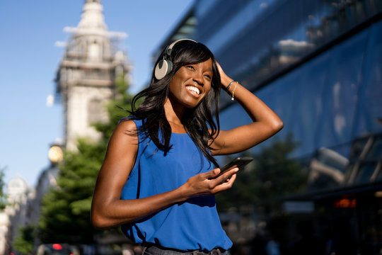 Female Afro-American listening to music in London, England, Great Britain