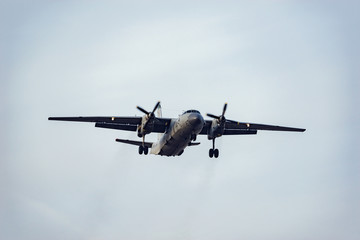 Freight military plane in the clear sky at evening time.