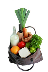 Concept of healthy food shopping. Shopping bag with organic products - bottle of milk, vegetables, bread, greenery and wine, oil. On white. Closeup. Selective focus.