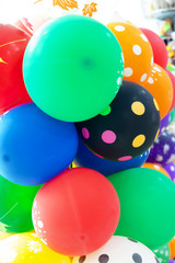 Background image of bright, colorful, inflated balloons.