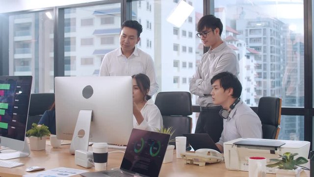 Collaborative process of multicultural businesspeople using computer presentation and communication meeting brainstorming ideas about project colleagues working plan success strategy in modern office.