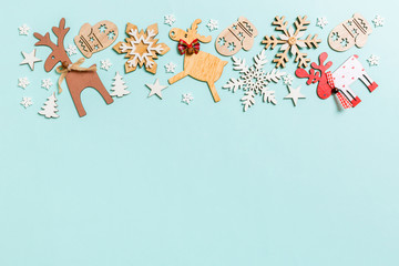 Top view of holiday decorations and toys on blue background. Christmas ornament concept with empty space for your design