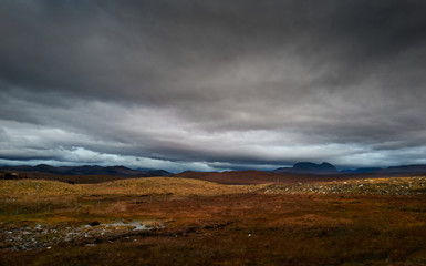 Fototapeta na wymiar Dark storm clouds building over the Torridon mountains in winter in the North West Highlands of Scotland, UK.