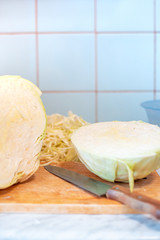 cut along a head of fresh cabbage lies on a table
