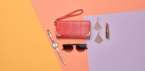 Woman beauty cosmetic makeup accessories Flat lay. Fashion Minimal Set. Trendy Design Clutch, lipstick. Art Concept colorful Style. Creative fashionable cosmetics, orange purple color, banner