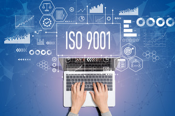 ISO 9001 concept with person using a laptop computer