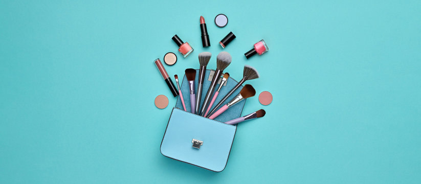 Fashion beauty product set. Woman Essentials cosmetic makeup Flat lay. Collection beauty accessories. Trendy Clutch, Brushes. Coloful art. Creative make up cosmetics blue concept, banner