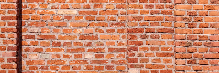 Background from a wall of red bricks. Copy space. Panorama.