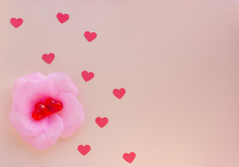 On a light background a lot of red hearts. Valentin's Day, top view. Artificial flower