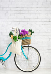 Fototapeta na wymiar Retro bike with wildflowers and organic vegetables