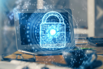 Double exposure of desktop with computer and lock icon hologram. Concept of data safety.