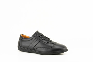 Black leather sneakers isolated on white background.