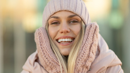 Portrait of a beautiful young model in pink knitted hat  and mittens. Beautiful natural young...