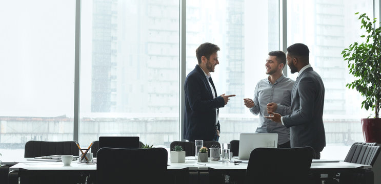 Businessmen Talking By Conference Table In Office, Free Space