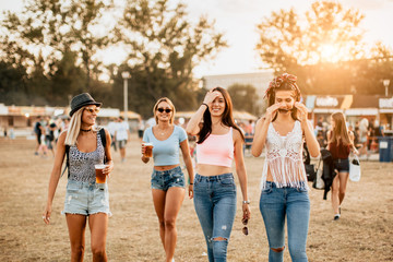 Female friends arriving at music festival