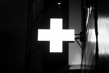 Glowing neon Cross hospital medical icon. First aid. Diagnostics symbol. Medicine and pharmacy sign.