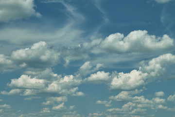 Beautiful clouds in the blue sky on a spring day in the sunlight.