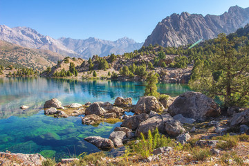 Beautiful mountain nature landscape on sunny summer day. Alaudin lake in Fann mountains, Tajikistan. Scenic with on blue water in lakes in Pamir-Alay valley