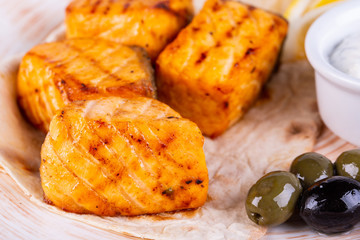 Fried fish on coals with olives