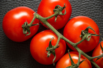 fresh tomatoes on black background