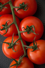 fresh tomatoes on black background
