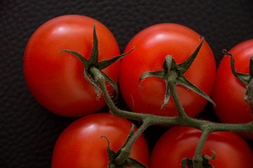 fresh tomatoes on black background