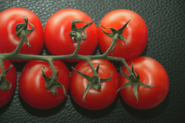 fresh tomatoes on black background