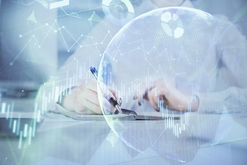 Financial chart drawn over hands taking notes background. Concept of research. Multi exposure