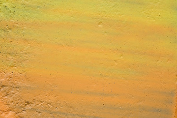 texture of a painted wall. cement plate yellow color background. wall with bumps and small pits.
