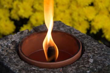 Memorial fire on a background of flowers