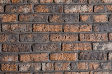 Red and gray brick wall with cement gaps. The old wall. Background, brick. Flat lay. Copy space, photo background.