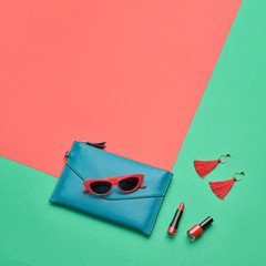 Fashion party girl Flat lay. Minimal. Woman Essentials accessories. Trendy Clutch, sunglasses, cosmetic makeup. Coloful coral geometry Set. Creative pop art concept, vibrant fashionable color