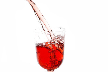 Glass of wine with splashes on a white background