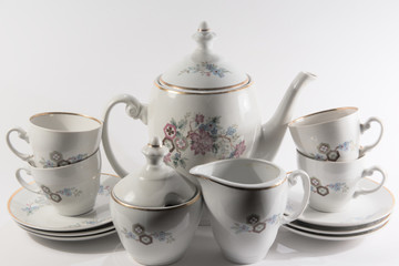 teapot and cups on white background