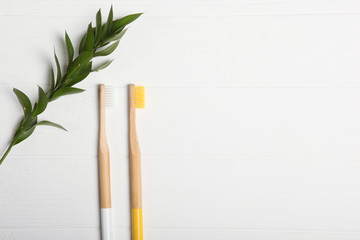 natural bamboo toothbrushes on a light background top view. Oral and dental care.