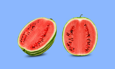 Green, striped watermelon, blue background with copy space for text, images. Cross-section. Berry with pink flesh, black seeds. Side view. Close-up.