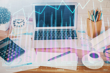 Fototapeta na wymiar Financial market graph hologram and personal computer on background. Multi exposure. Concept of forex.