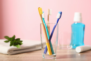 Natural bamboo and plastic toothbrushes on the table.