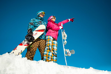 A pair of snowboarders on a slope