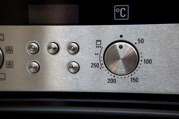 closeup of oven dashboard with grey buttons