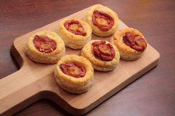 small pizzas on cutting board and wooden table