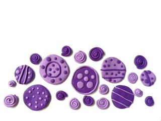 Plasticine clay handmade are cute purple circle and roll on white background, Variety of patterns dough