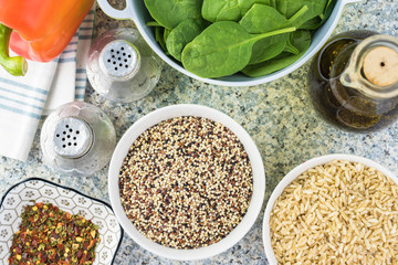 Cooked spinach quinoa brown rice with vegetables and berries.