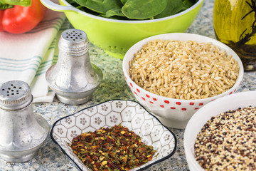 Cooked spinach quinoa brown rice with vegetables and berries.