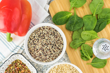 Cooked spinach quinoa brown rice with vegetables and berries.