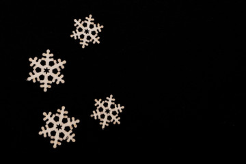 handmade wooden snowflakes isolated on black background, beautiful christmas decoration